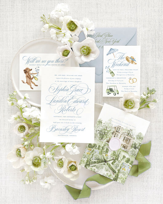 Luxury Barnsley Resort wedding invitation suite featuring a watercolor vellum cover with venue artwork, custom watercolor wedding weekend icons, playful dog illustration, wax seal, and elegant fine art stationery styled with soft blue and green details.