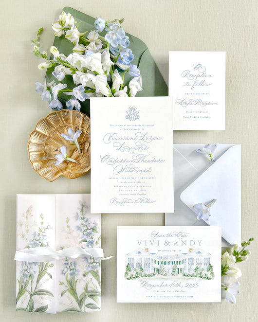 Luxury wedding invitation suite featuring a watercolor illustration of The Duke Mansion in Charlotte, North Carolina, with soft blue florals, letterpress invitations, vellum wrap, and elegant fine art wedding stationery styling.