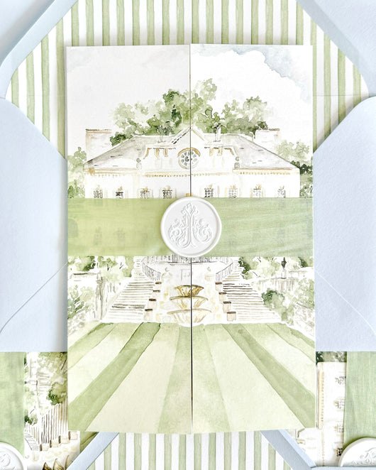 Luxury gatefold wedding invitation featuring a watercolor illustration of the Swan House in Atlanta, Georgia, with soft green ribbon, custom wax seal, striped envelope liner, and elegant fine art wedding stationery details.