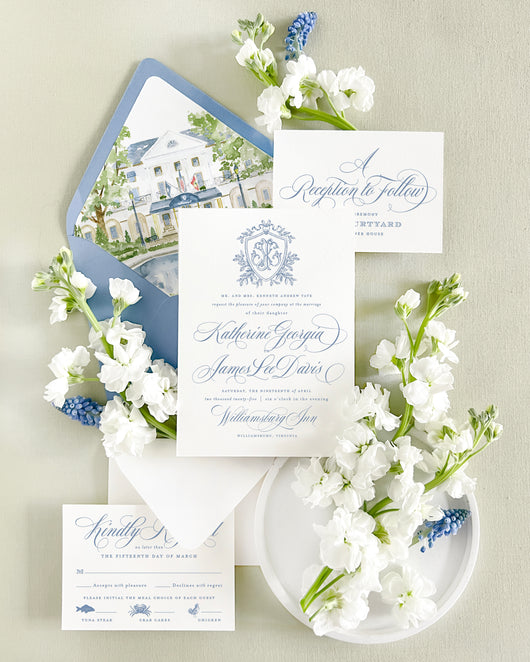 Luxury wedding invitation suite featuring a custom watercolor painting of the Williamsburg Inn in Williamsburg, Virginia with fine art blue and white wedding stationery, watercolor envelope liner, elegant script typography, and classic Southern wedding invitation design.